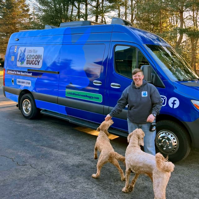 Owner Amy outside van with two client pups